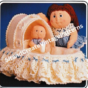 May include: A crocheted baby doll in a white bassinet with a crocheted doll holding a bottle. The doll is wearing a blue dress with white trim. The bassinet is decorated with blue bows.