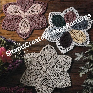 May include: Three crocheted doilies in different colors and patterns. The doilies are white, pink, and green. The doilies are on a wooden surface.