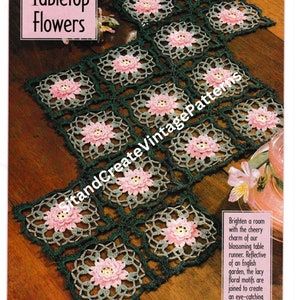 May include: A crochet table runner featuring a green and pink floral design. The runner is made up of square motifs with a flower in the centre. The text "Tabletop Flowers" is at the top of the image.