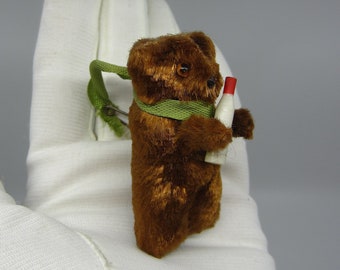 Very small vintage toy bear holding a milk bottle 2.12&quot; Tiny miniature teddy Glass eyes Pin attached to its ribbon Mascot / lucky charm?