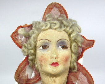 Bizarre antique decoration made of French boudoir doll head & red "petals" / star Decadent wall decor Brown eyes Curly hair Old and unique