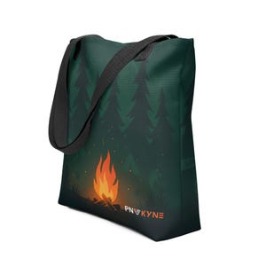 May include: Green tote bag featuring a campfire scene with a forest backdrop. The design includes a bright orange and yellow campfire with the text "PNWKYNE" in orange. The bag has a black strap.