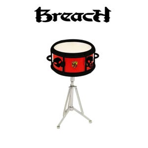May include: A red snare drum with black skull and alien head graphics, on a silver stand. The drum has a white drumhead and the word "Breach" in black gothic font above it.