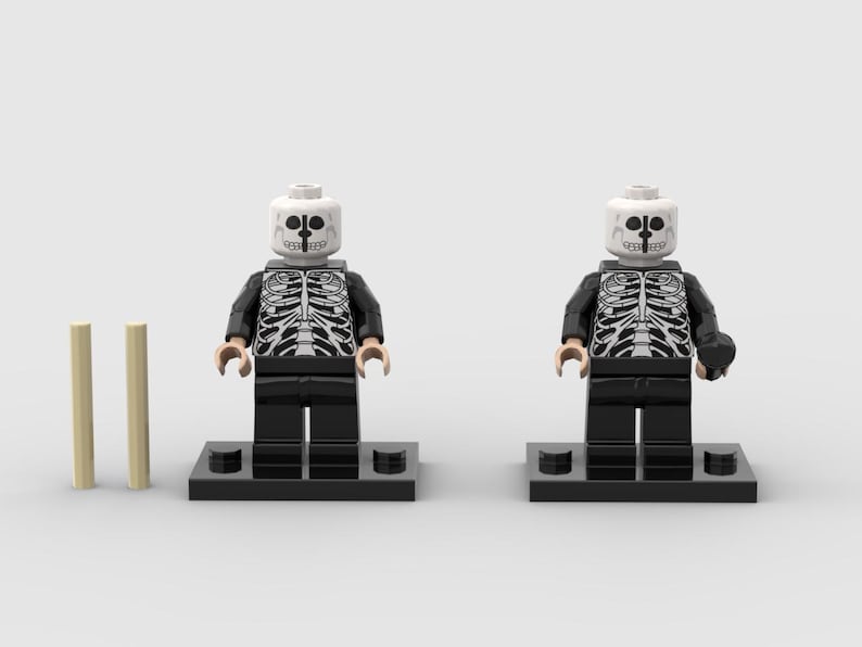 May include: Two Lego skeleton minifigures with black jackets and pants, white skeleton torso print, and white skull heads. Two tan Lego cylinders are to the left of the figures. The figures stand on black Lego bases.
