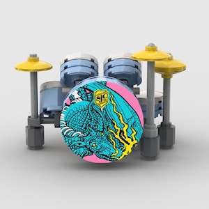 May include: A miniature drum set made of building blocks. The drum features a pink and teal graphic of a dragon. The set includes light blue drums, yellow cymbals, and gray supports.