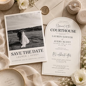 May include: A rectangular Save the Date card featuring a black and white photo of a couple in a field, and an arched wedding invitation card with black text reading Elopement at the Courthouse for Lauren Sawyer and Avery Scott on April 26, 2025.