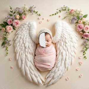 May include: A newborn baby wearing a pink swaddle and a white hat is lying on a white background with white angel wings. The baby is surrounded by pink and white flowers.