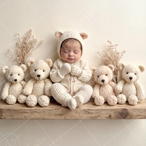 May include: A newborn baby wearing a white knitted bear costume is surrounded by four plush teddy bears on a wooden shelf. The baby is sleeping with its hands clasped together. The teddy bears are all white and have brown eyes.