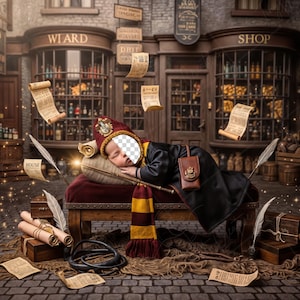May include: A baby in a wizard costume, asleep on a small wooden bench. The scene is set in a shop with scrolls, quills, and a wand. The baby wears a red and gold hat and scarf, with a black robe.