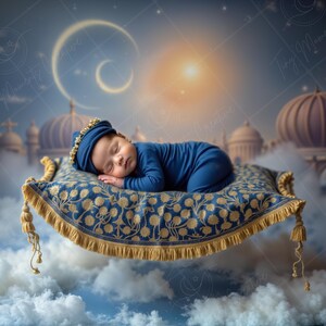 May include: A sleeping baby in a blue outfit and hat rests on a patterned magic carpet with gold fringe. The background features a fantasy cityscape with domes, clouds, and a crescent moon.