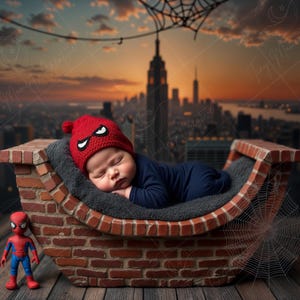 May include: A baby wearing a red knit hat with a spider-man design sleeps in a brick-shaped bed with a spider web design. A small spider-man figurine is in the foreground.