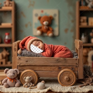 May include: A newborn baby wearing an orange outfit and a matching cap, sleeping in a wooden wagon bed. The scene is decorated with teddy bears and wooden toys, creating a cozy nursery setting.