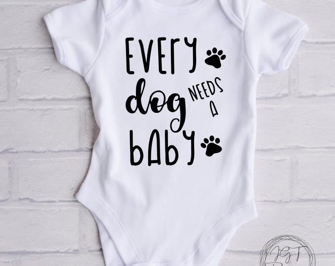 Every Dog Needs A Baby Baby Onesie® Bodysuit -  Newborn Tee