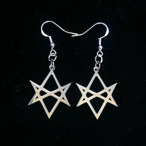 May include: A pair of silver earrings with a six-pointed star design. The star is made of thin metal and has a geometric pattern.