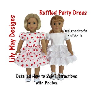 May include: Two 18-inch doll dresses, one white with lace trim and one red and white with hearts. The dresses are ruffled and designed to fit 18-inch dolls. The image includes the text "Ruffled Party Dress" and "Designed to fit 18" dolls".