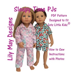 May include: Two dolls wearing pajamas. One doll is in a pink and blue scale-patterned pajama set. The other doll is in a blue, red, and white dog-patterned pajama set. Text on the image reads "Sleepy Time PJs" and "Lily May Designs".