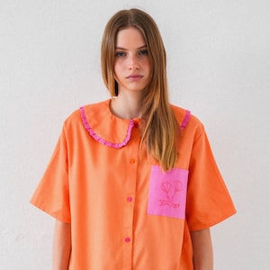 Hand Embroidered vibrant shirt in coral orange and hot pink details