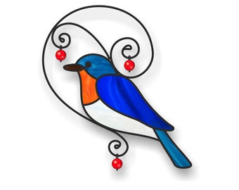 May include: A stained glass bluebird with an orange breast and white belly. The bird is perched on a black metal swirl with three red glass beads.