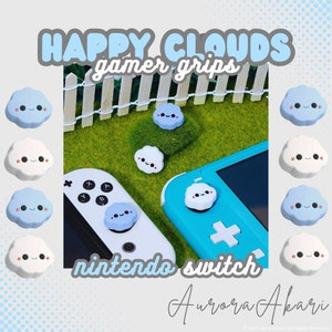 May include: A collection of cloud-shaped joystick covers for a gaming console. The covers are light blue and white with smiling faces, black eyes, and pink cheeks. Text on the image reads HAPPY CLOUDS gamer grips, nintendo switch, and Aurora Akari.