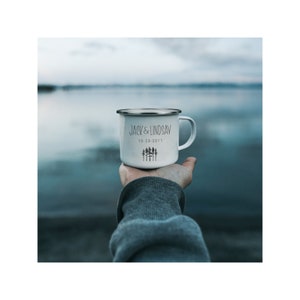 May include: White enamel camping mug with a black inscription that reads "Jack & Lindsay 10-20-2011" and a small graphic of a forest.