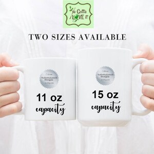May include: Two white ceramic mugs with black text. The mug on the left is 11 oz and the mug on the right is 15 oz.
