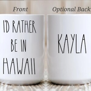 May include: White ceramic mug with the text "I'D RATHER BE IN HAWAII" on the front and the name "KAYLA" on the back. The mug is 15oz.