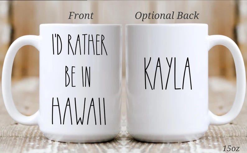 May include: White ceramic mug with the text "I'D RATHER BE IN HAWAII" on the front and the name "KAYLA" on the back. The mug is 15oz.
