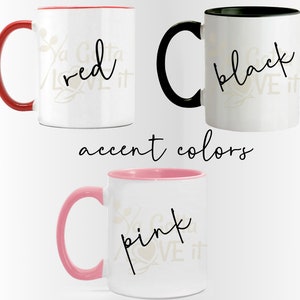 May include: Three white ceramic mugs with different colored accent rims. The mugs have a black cursive design that says "Ya Gotta Love It" with a different color word in the middle of the phrase. The colors are red, black, and pink.