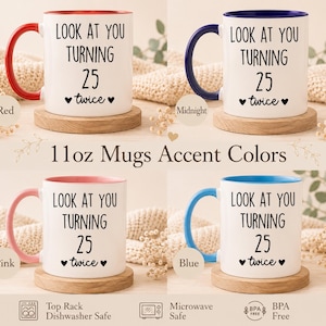 May include: Four 11oz ceramic mugs with white exteriors and colored handles and interiors in red, midnight blue, pink, and light blue. Each mug features the black text "LOOK AT YOU TURNING 25 twice" with small heart icons on the front surface.