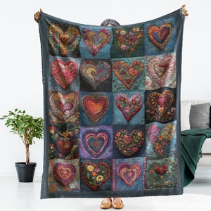 May include: A blue throw blanket with a patchwork design of 20 colorful embroidered hearts. The blanket is 50 inches by 60 inches.