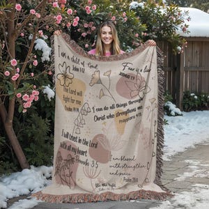 May include: Beige woven throw blanket with floral and botanical designs, and inspirational text. The blanket features quotes from the Bible, including "I am a child of God" and "Fear is a liar."