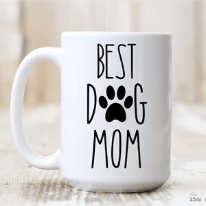 May include: White ceramic mug with a black paw print and the text "BEST DOG MOM" printed on it.