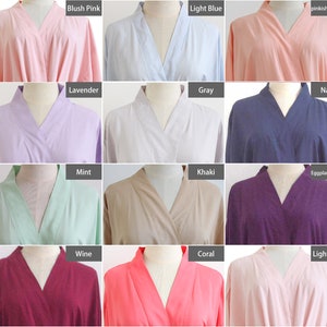 May include: A collection of twelve robes displayed on mannequins, featuring a variety of solid colors including blush pink, light blue, pinkish-orange, lavender, gray, navy, mint, khaki, eggplant purple, wine, coral, and light pink.