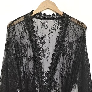 May include: Black lace robe with a V-neckline and long sleeves. The robe is made of delicate, sheer lace and has a floral pattern.
