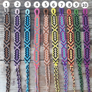 May include: Ten colorful friendship bracelets with different geometric patterns. The bracelets are made with colorful embroidery floss and have a knot at the end. The bracelets are numbered 1 through 10.