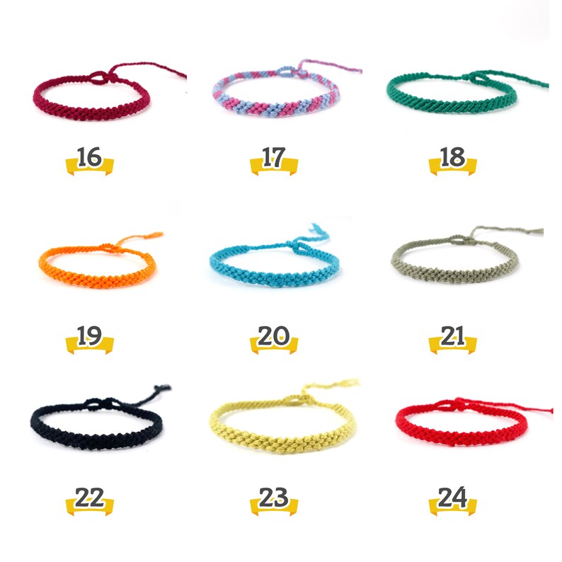 May include: Nine different colors of friendship bracelets, each tied in a knot. The bracelets are made of thin, braided string. The colors are burgundy, pink and blue, green, orange, turquoise, gray, black, yellow, and red.