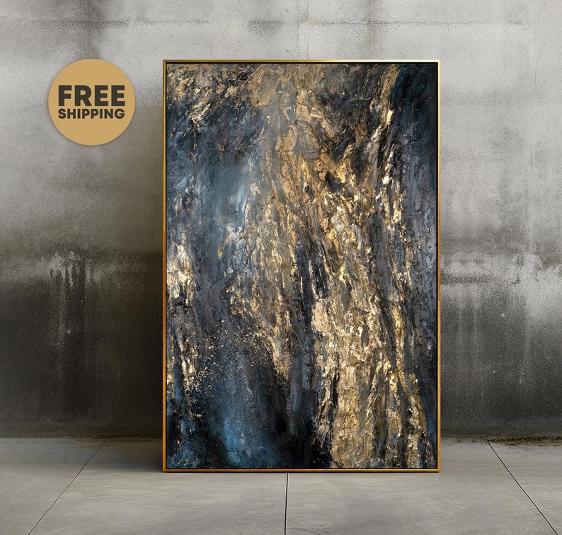 May include: Abstract painting with gold and blue hues on a canvas. The painting has a textured surface and is framed in a gold frame.