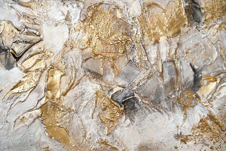 May include: Abstract painting with textured gold and white paint. The paint is applied in thick layers, creating a dynamic and modern look.