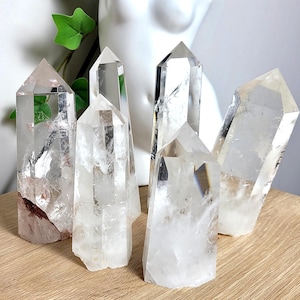 May include: A handmade, wooden cutting board with a natural finish. The board features a live edge on one side and a rectangular shape. It is approximately 18 inches long, 12 inches wide, and 1 inch thick.