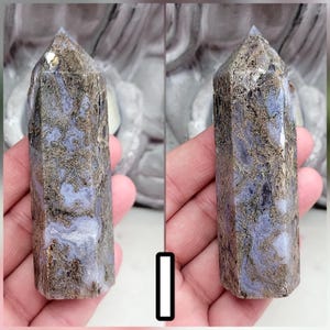 May include: A polished crystal tower with a hexagonal point, featuring a marbled pattern of light lavender and periwinkle blue stone interspersed with intricate, web-like veins of metallic bronze and dark brown mineral inclusions throughout.