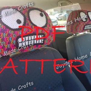 May include: A crochet car headrest pattern with a colourful, textured design and a cartoon face with large eyes and a toothy grin. The pattern is available as a PDF download. The text "PDF PATTERN" is written in red across the image.