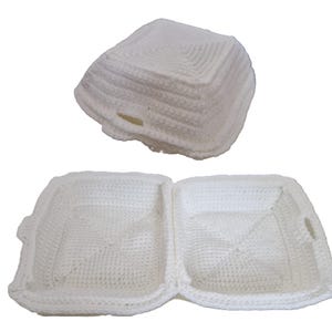 May include: Two-piece white crocheted container, one piece closed and the other open. The open container has two compartments and small handles on each side. The closed container is a square shape with a small opening.