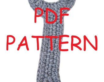 May include: A gray, crocheted item in a unique shape, possibly a tool or decorative piece. The text "PDF PATTERN" is written in red over the object. The item has a loop at the bottom and a textured surface.