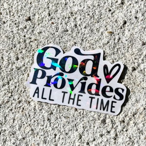 Puede incluir: Una pegatina holográfica con las palabras "God Provides ALL THE TIME" en escritura negra. La pegatina tiene un borde blanco y está colocada sobre una superficie gris texturizada.