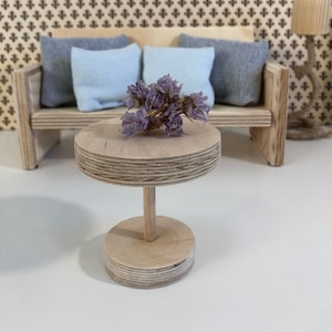 Cute Set of mini furniture for pretend play for a dollhouse. Miniature set of furniture for a doll with a sofa, an armchair and a table.