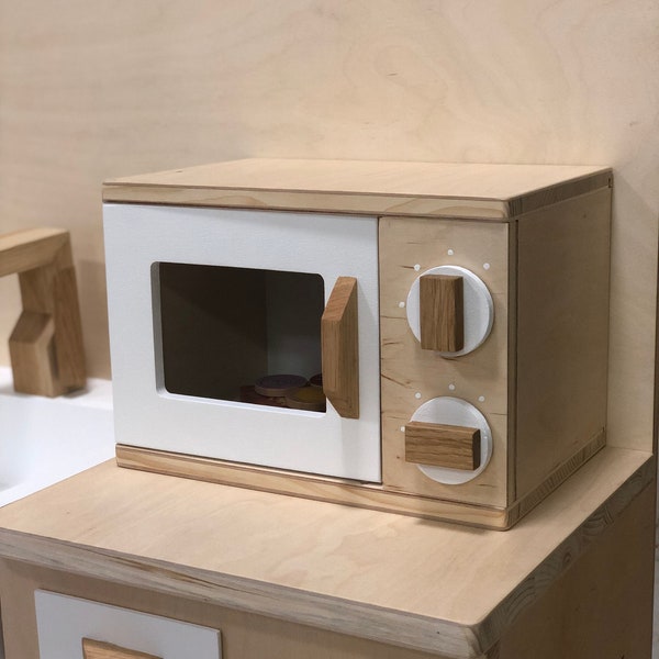 Wooden microwave oven for children to play. Wooden toy microwave for children. Nice wooden toy, a play stove