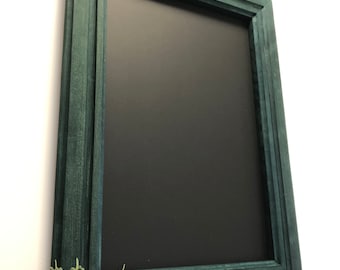 Magnetic board in a wooden frame, board in a green frame, board with magnets made of khaki wood