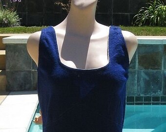 May include: A dark blue one-piece swimsuit with a scoop neck and a fitted silhouette. The swimsuit is made of a textured fabric and has a simple design.
