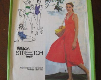 May include: Simplicity 9005 sewing pattern envelope. The cover features illustrations of swimwear designs and a woman in a red dress. The text includes "Stretch Knit" and size information.