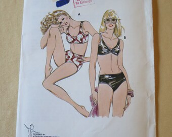 May include: A vintage Kwik Sew sewing pattern packet, pattern 153, featuring illustrations of two different lingerie sets. The packet includes the text "No Refund No Exchange" and lists sizes 14-16-18-20. Designed by Kerstin Martensson.